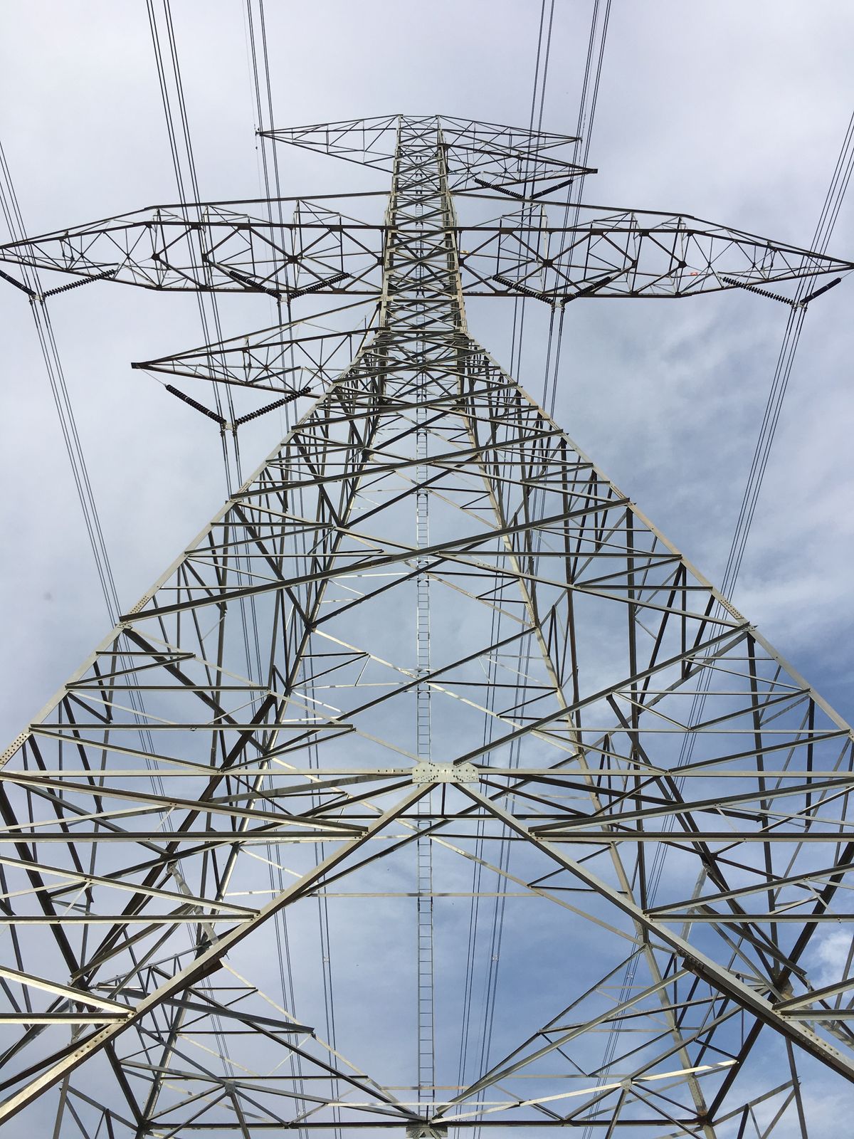 Suspension tower with vertical insulator strings seen from below